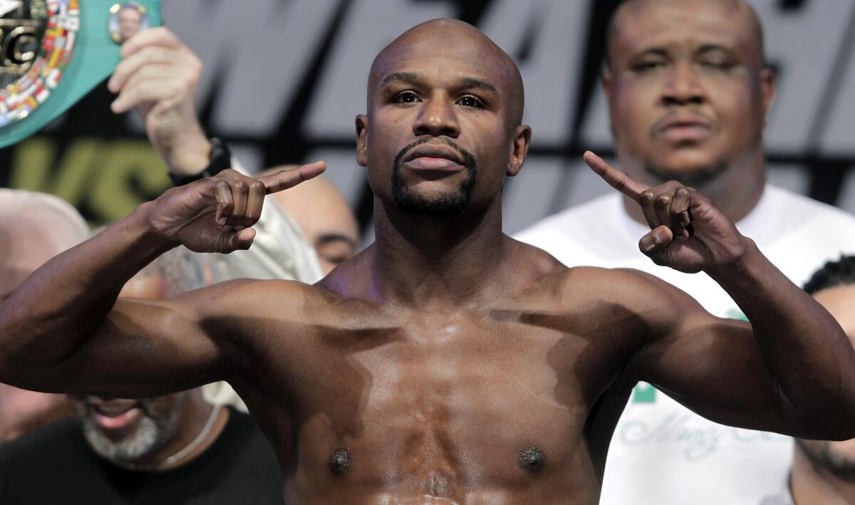 Undefeated boxer Floyd Mayweather Jr. weighs in before his fight with Marcos Maidana of Argentina in September.