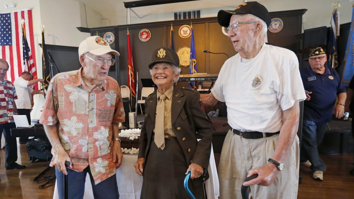 World War II veterans, from left, Earl Dahleen, Mary Joan Morris and Leander Kelter attend a party Thursday at the American Legion’s Newport Harbor Post 291. WWII and Korean War veterans were the guests of honor.
