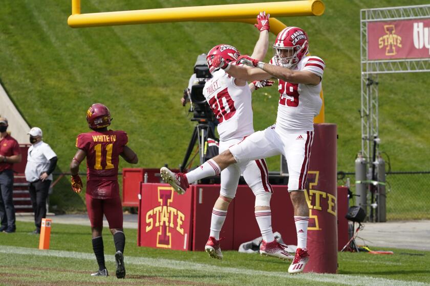 Louisiana-Lafayette wide receiver Peter LeBlanc (29) celebrates with teammate (80) Devon Pauley in front of Iowa State defensive back Lawrence White IV (11) after catching a 78-yard touchdown pass during the second half of an NCAA college football game, Saturday, Sept. 12, 2020, in Ames, Iowa. Louisiana-Lafayette won 31-14. (AP Photo/Charlie Neibergall)