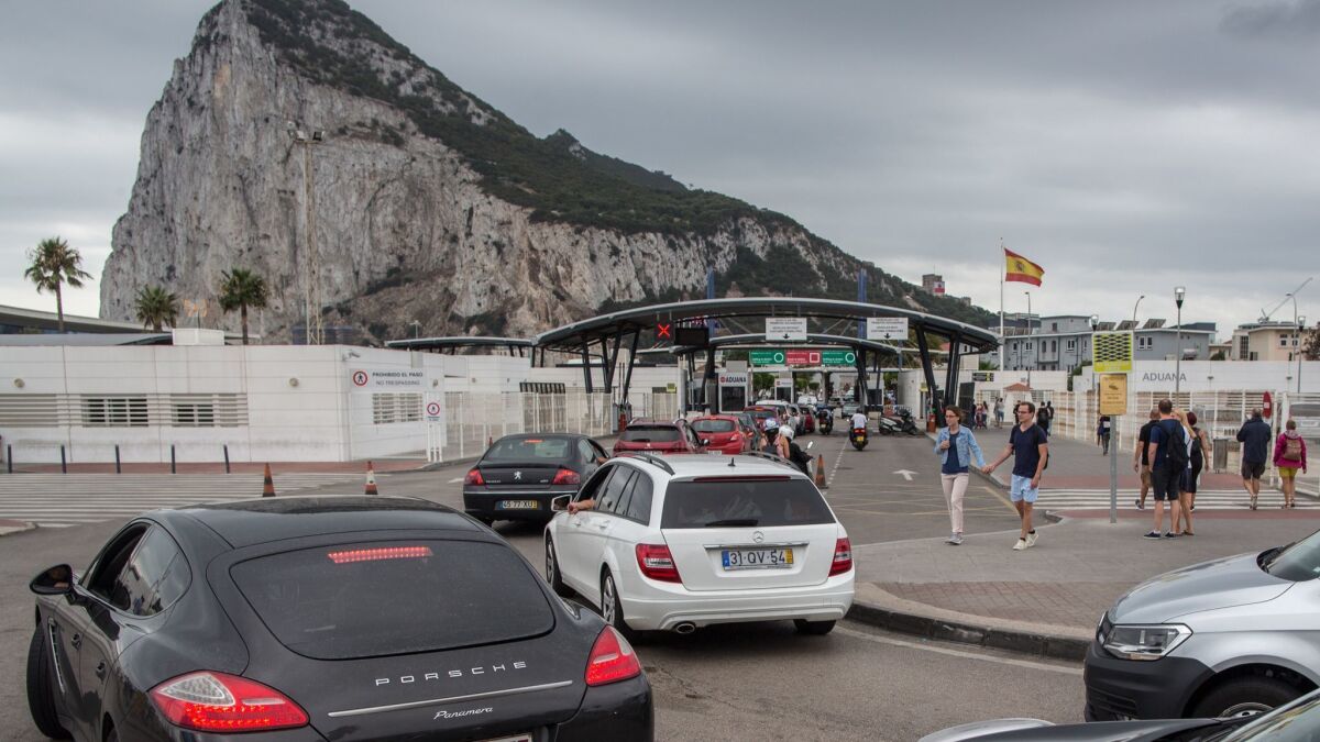 People cross the frontier from Spain into Gibraltar. The effects of "Brexit" on the self-governing enclave of 34,000 residents, where 96% of voters favored remaining in the European Union, remains unclear.