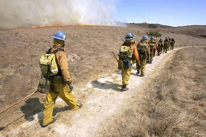 LA County firefighters move to battle a blaze near Chesebro Canyon.