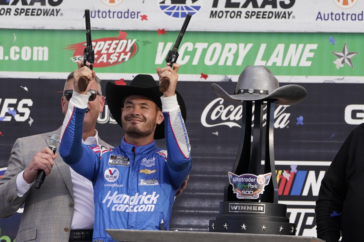Kyle Larson (5) celebrates after winning a NASCAR Cup Series auto race at Texas Motor Speedway Sunday, Oct. 17, 2021, in Fort Worth, Texas. (AP Photo/Larry Papke)