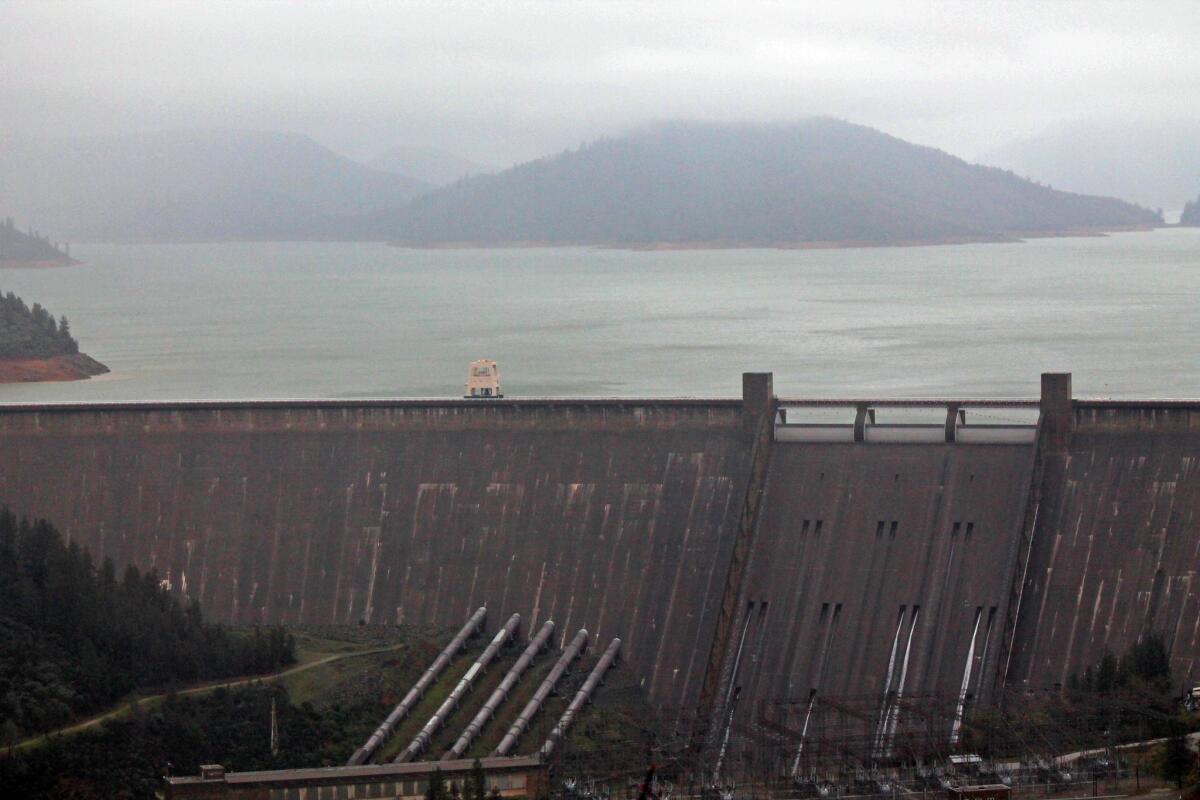El Niño-driven storms have raised water levels to near capacity in Lake Shasta, seen here behind Shasta Dam.