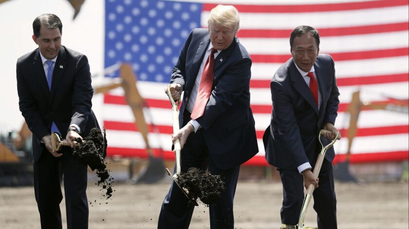 President Trump, with then-Wisconsin Gov. Scott Walker, left, and Foxconn Chairman Terry Gou, participates in a June groundbreaking for the Wisconsin Foxconn facility.