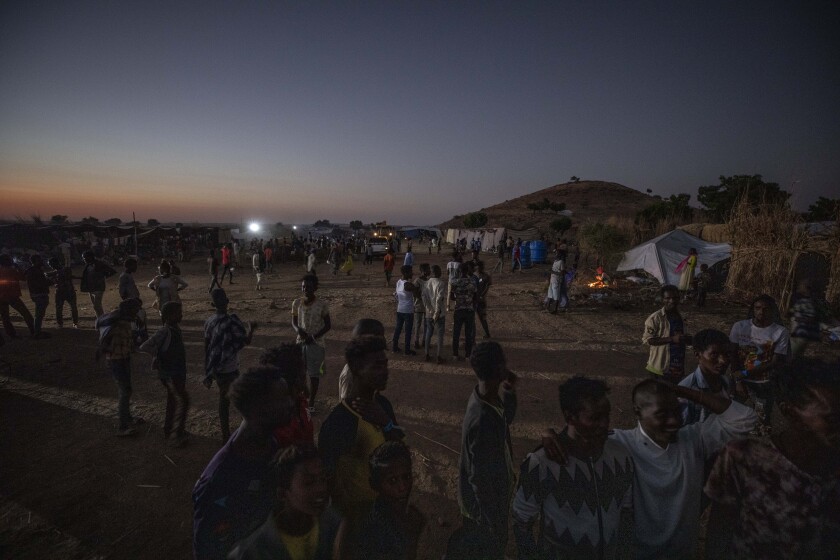 Tigray people who fled the conflict in Ethiopia's Tigray region, walk at Umm Rakouba refugee camp in Qadarif, eastern Sudan, Friday, Nov. 27, 2020. Ethiopian Prime Minister Abiy Ahmed again ruled out dialogue with the leaders of the defiant Tigray region Friday but said he was willing to speak to representatives "operating legally" there during a meeting with three African Union special envoys trying to end the deadly conflict between federal troops and the region's forces. (AP Photo/Nariman El-Mofty)