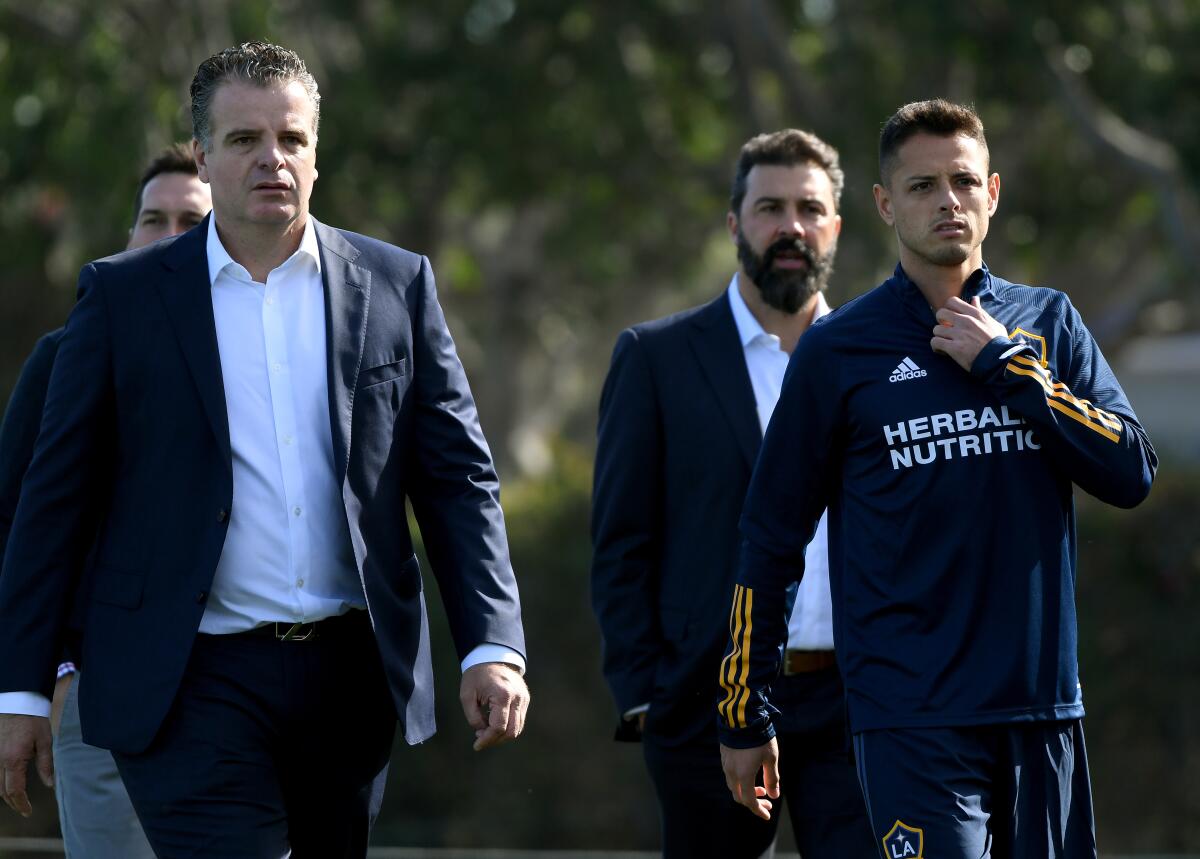 Galaxy general manager Dennis te Kloese, left, and Javier "Chicharito" Hernandez walk together before a team practice session in January.