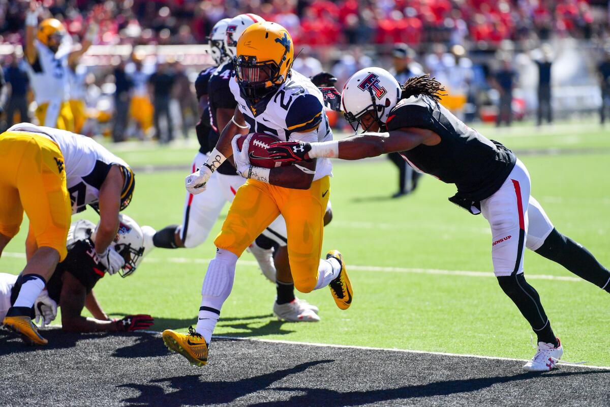 West Virginia's Justin Crawford (25) scores a touchdown against Texas Tech on Saturday.