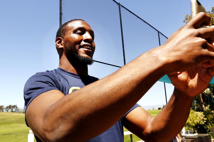 Rams defensive end Robert Quinn takes a selfie for Snapchat session following a news conference this spring.