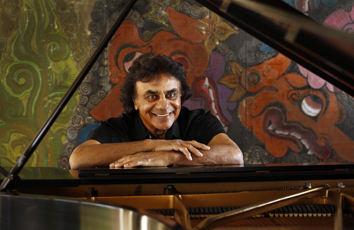 Legendary singer Johnny Mathis at his Hollywood Hills home, which was damaged in a fire Monday evening, authorities said.