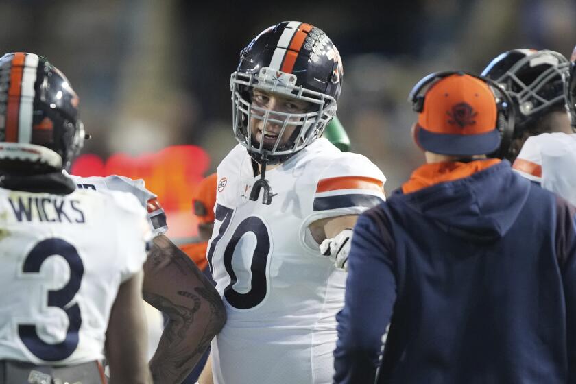 Virginia offensive tackle Bobby Haskins (70) gestures toward a coach in the second half during an NCAA college football game against BYU Saturday, Oct. 30, 2021, in Provo, Utah. (AP Photo/George Frey)