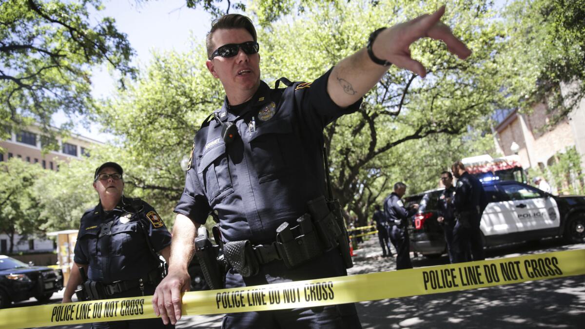 Law enforcement officers secure the scene after a fatal stabbing on the University of Texas campus.