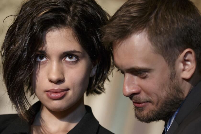 FILE - In this file photo taken on Tuesday, May 6, 2014, Russian political activist Nadya Tolokonnikova of the Russian punk band Pussy Riot, stands with her husband Pyotr Verzilov as they join Sen. Ben Cardin, D-Md., the chairman of the Helsinki Commission in seeking action to stop violations of human rights by pro-Russian militants in the Ukraine region, at the Capitol in Washington. Russian news reports say Verzilov, a member of Russian punk protest group Pussy Riot, has been hospitalized in grave condition for what could be a possible poisoning. (AP Photo/J. Scott Applewhite)