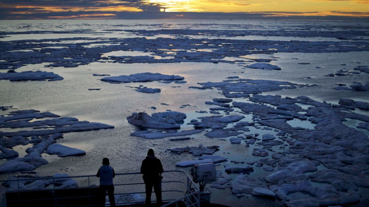 The crew of a Finnish icebreaker examines sea ice in Canada's Northwest Passage, which has been opening up sooner and for a longer period each summer due to climate change.
