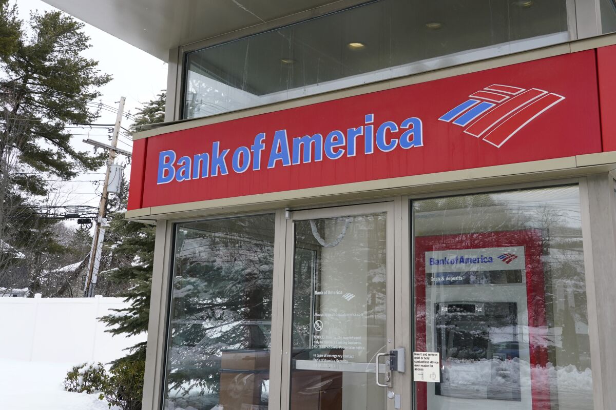 A Bank of America ATM is seen, Wednesday, Feb. 3, 2021, in Winchester, Mass. Bank of America said, Wednesday, Jan. 19, 2022, its profits rose 28% in the fourth quarter compared to a year earlier, but the bank faced the same wage inflation as its Wall Street counterparts.(AP Photo/Elise Amendola)