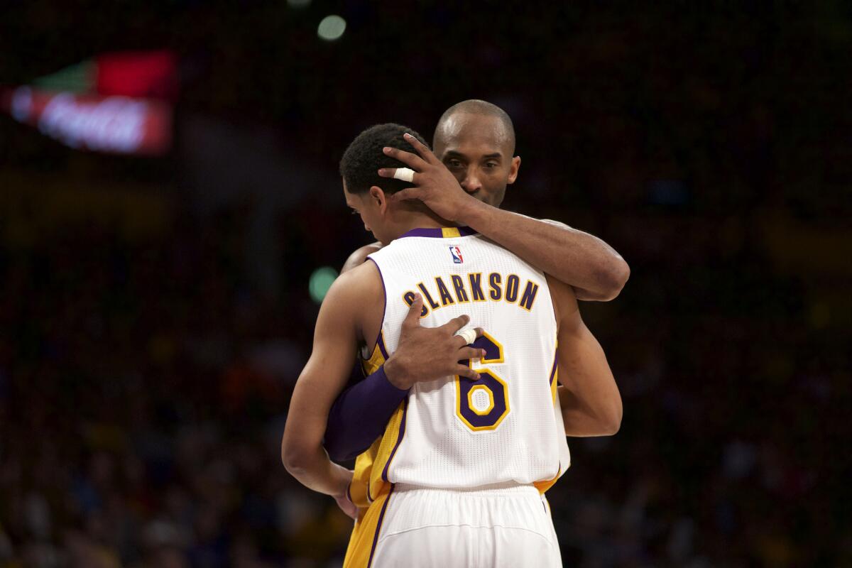 Kobe Bryant hugs teammate Jordan Clarkson during the Lakers' 112-95 win over the Golden State Warriors at Staples Center on March 6.