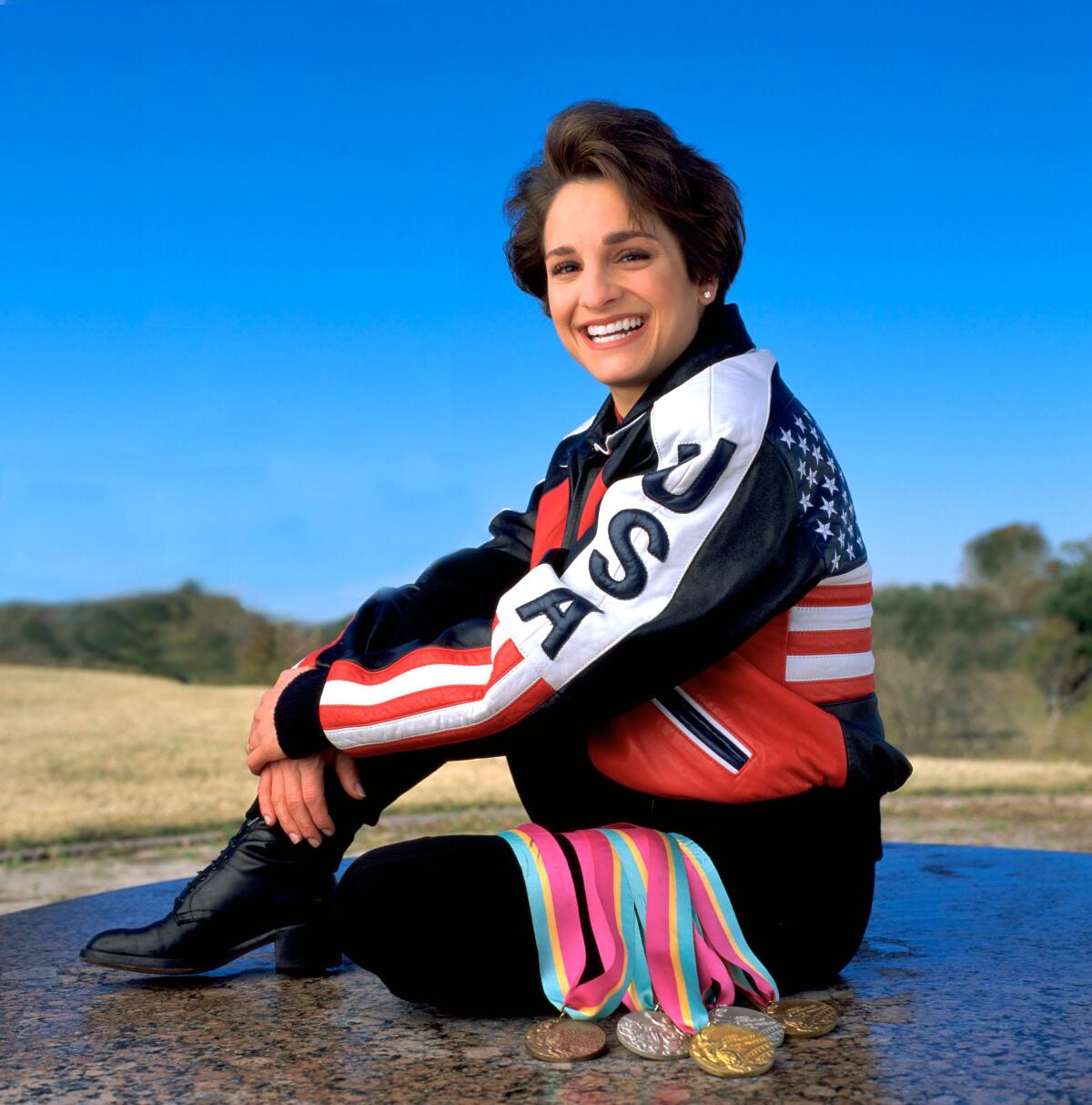 Mary Lou Retton smiles and poses in a USA tracksuit for a photo shoot in 2000.