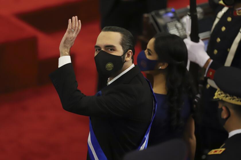 FILE - In this June 1, 2021 file photo, El Salvador's President Nayib Bukele waves during his annual address to the nation before Congress, in San Salvador, El Salvador. El Salvador’s top court and its election authority have tossed aside what seemed to be a constitutional ban on consecutive presidential reelection, announced Saturday, Sept. 4, 2021. That sets the stage for Bukele to seek a second term in 2024. (AP Photo/Salvador Melendez, File)
