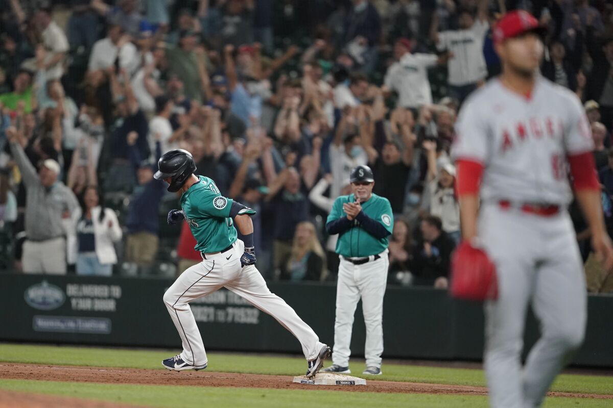 Angels pitcher José Quintana reacts after allowing a grand slam as Seattle's Mitch Haniger circles the bases