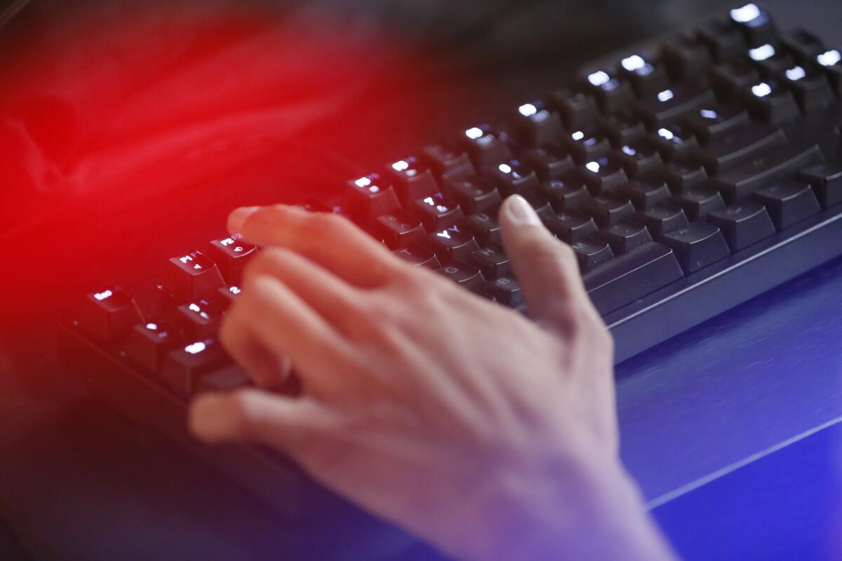 Online video game player's hands on keyboard