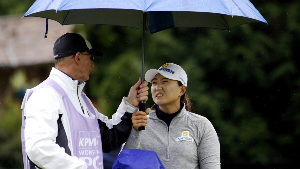 Mirim Lee and caddie Daryl Smith talk strategy on the seventh hole Friday during the second round of the Women¿s PGA Championship.