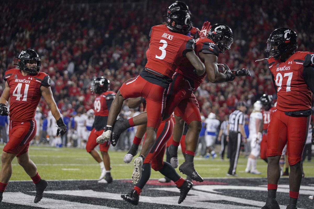 Cincinnati defensive lineman Jabari Taylor, center right, celebrates with teammates after recovering a fumble in the end zone during the second half of an NCAA college football game against Tulsa Saturday, Nov. 6, 2021, in Cincinnati. (AP Photo/Jeff Dean)