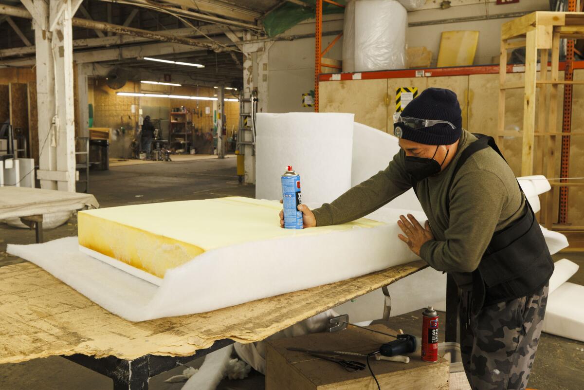 A worker upholsters furniture at Vesta