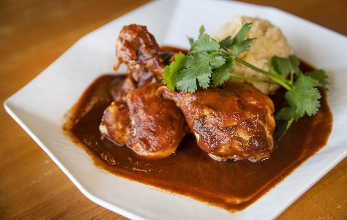 Mole colorado — -red mole served with chicken and rice — is on the menu at Quiadaiyn, a Oaxacan-style restaurant in Mar Vista.