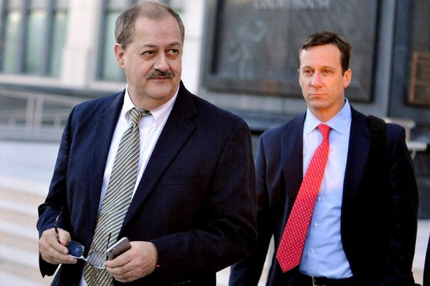 FILE - In a Tuesday, Nov. 24, 2015, file photo, former Massey Energy CEO Don Blankenship, left, walks out of the Robert C. Byrd U.S. Courthouse after the jury deliberated for a fifth full day in his trial, in Charleston, W. Va. Blankenship is finishing up his one-year federal prison sentence related to the deadliest U.S. mine explosion in four decades. According to the U.S. Bureau of Prisons website, Blankenship is set to be released Wednesday, May 10, 2017, from a halfway house in Phoenix. He must serve one year of supervised release. (AP Photo/Chris Tilley, File)