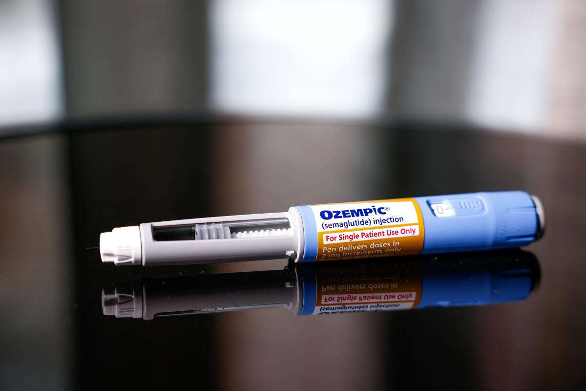An Ozempic injection pen is seen on a table.