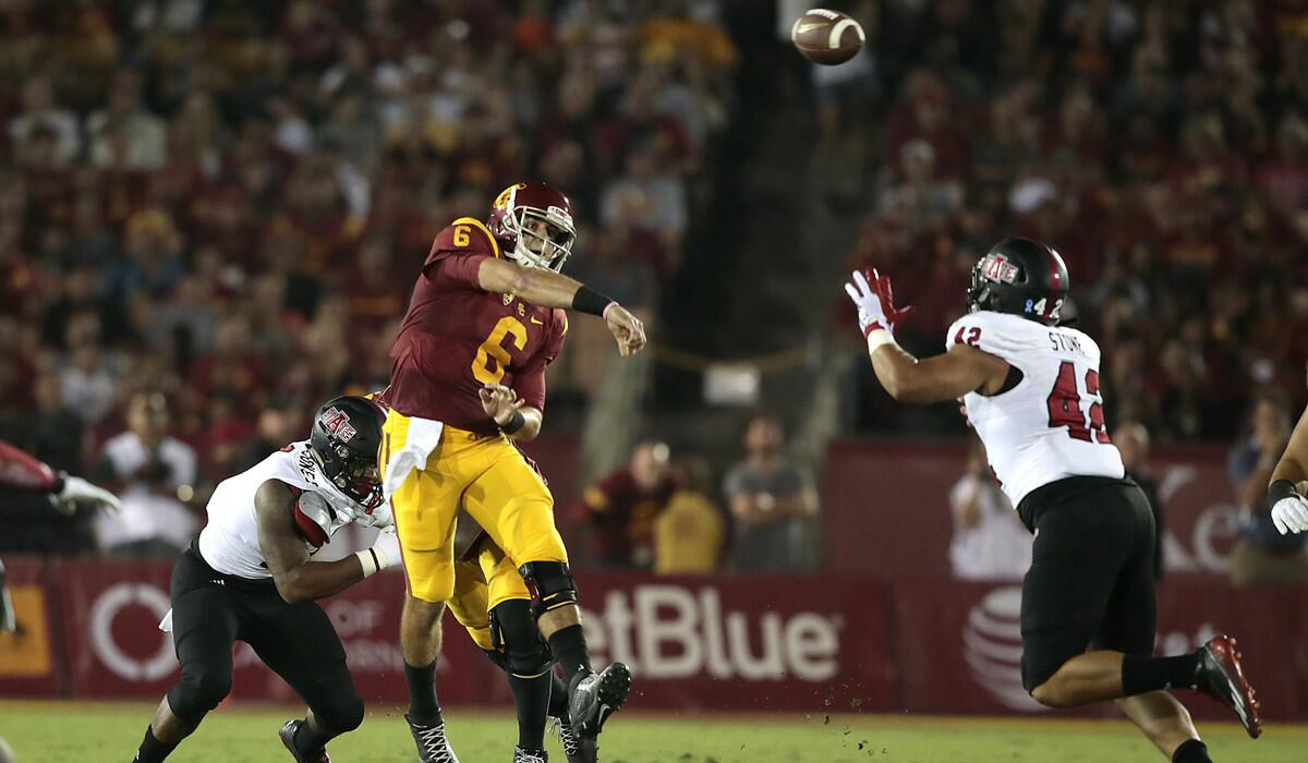 USC quarterback Cody Kessler passes downfield during first quarter action against Arkansas State at the Coliseum on Saturday.