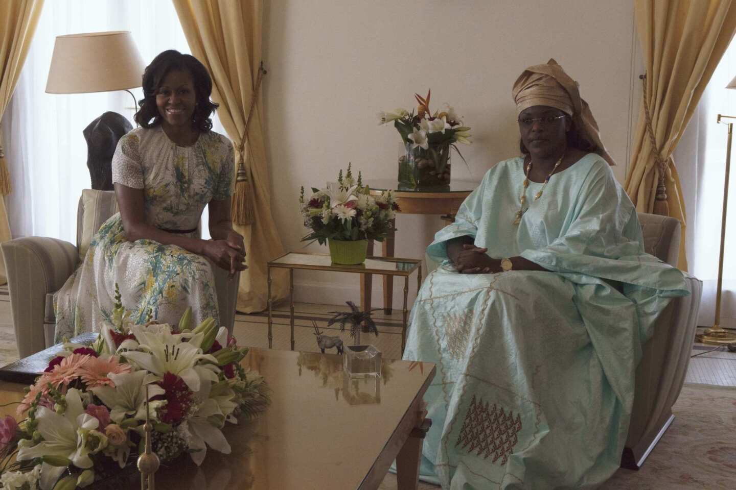 U.S. first lady Obama sits with Senegalese First Lady Faye Sall at the presidential palace in Dakar