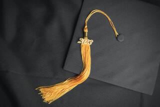 A class of 2023 tassel on a black cap with a gown.