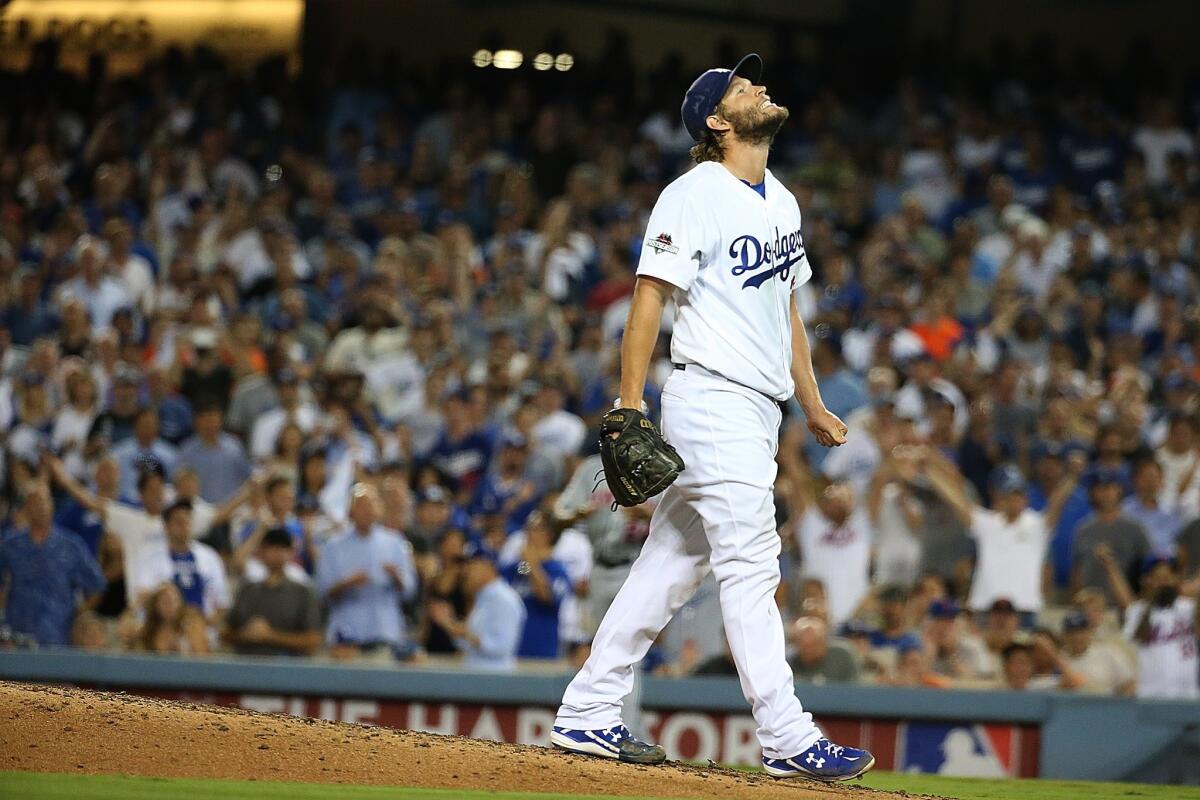 Dodgers pitcher Clayton Kershaw grimaces after walking Mets hitter Curtis Granderson to load the bases in the seventh inning.