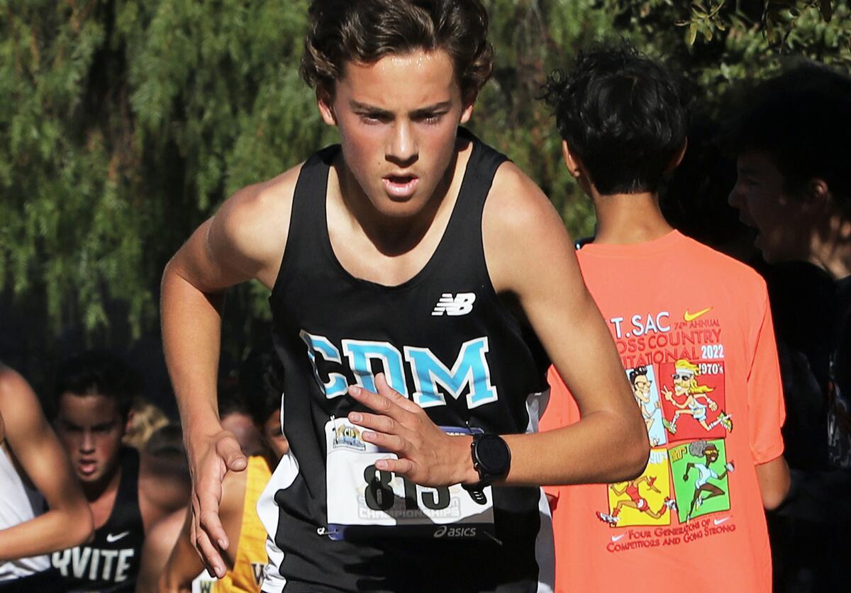 Corona del Mar's Kevin Steinman (813) runs up "Poop Out" hill in the boys' Division 3 race of the CIF finals on Saturday.