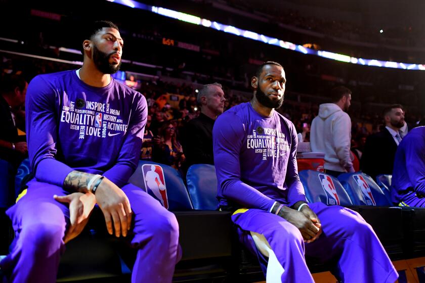 LOS ANGELES, CALIFORNIA FEBUARY 4, 2020-Lakers Anthony Davis, left, and LeBron James wait to be introduced before a game against the Spurs at the Staples Center Tuesday. (Wally Skalij/Los Angeles Times)