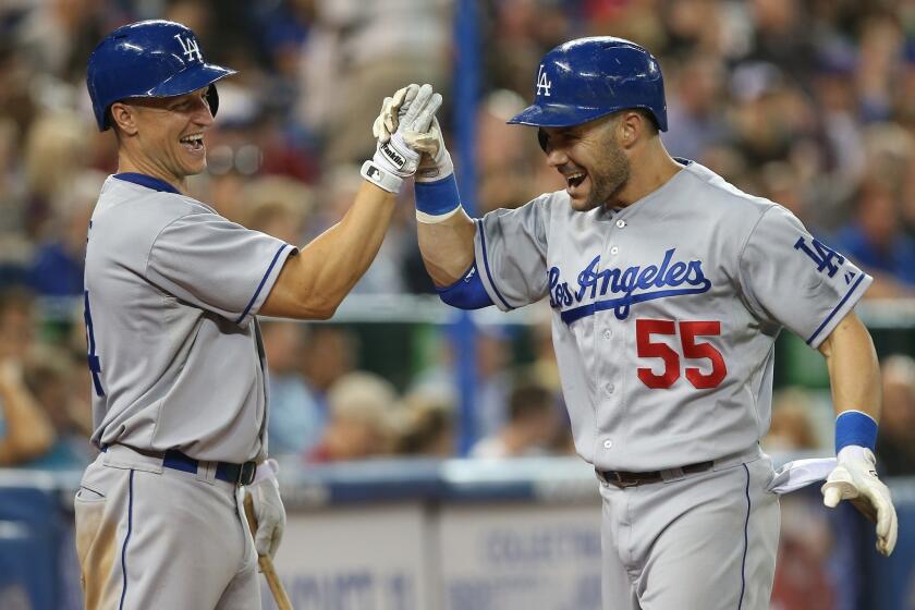 Skip Schumaker, right, is congratulated by Mark Ellis after hitting a three-run home run during the seventh inning of Monday's win over the Toronto Blue Jays.
