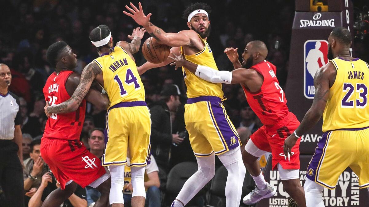 Rockets guard Chris Paul tries to get a pass by Lakers center JaVale McGee during a Feb. 21 game at Staples Center.