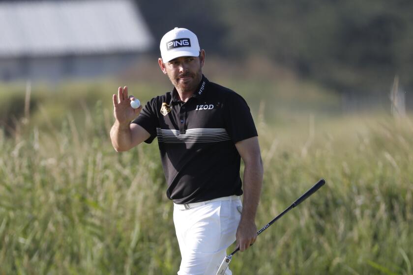 Louis Oosthuizen acknowledges the crowd after making an eagle on No. 14 during the second round of the British Open.