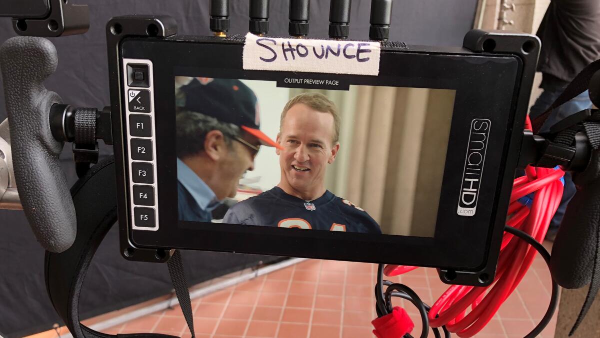 Former NFL quarterback Peyton Manning films a segment of his new ESPN+ documentary series in Chicago with comic Robert Smigel.