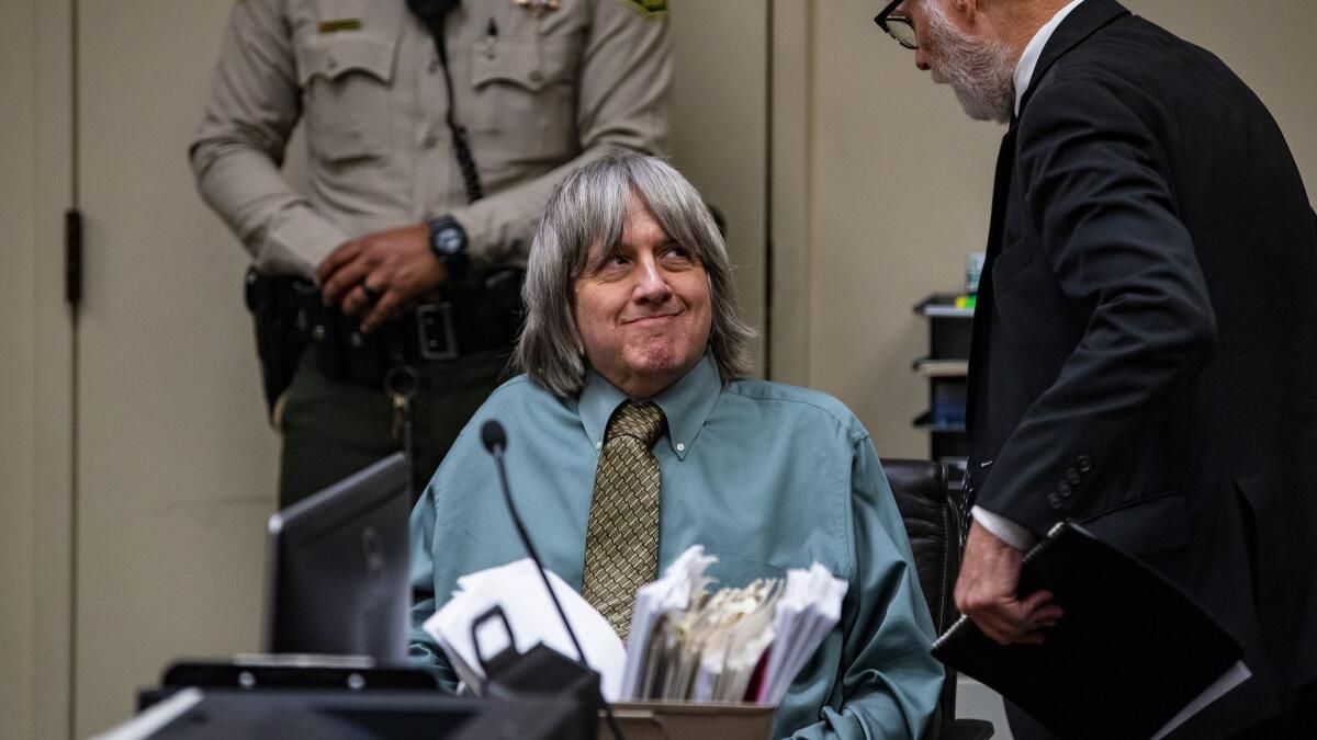 Perris torture defendant David Turpin confers with his defense attorney David Macher during a court appearance with his wife, Louise Turpin, at the Riverside Hall of Justice on May 4 in Riverside.