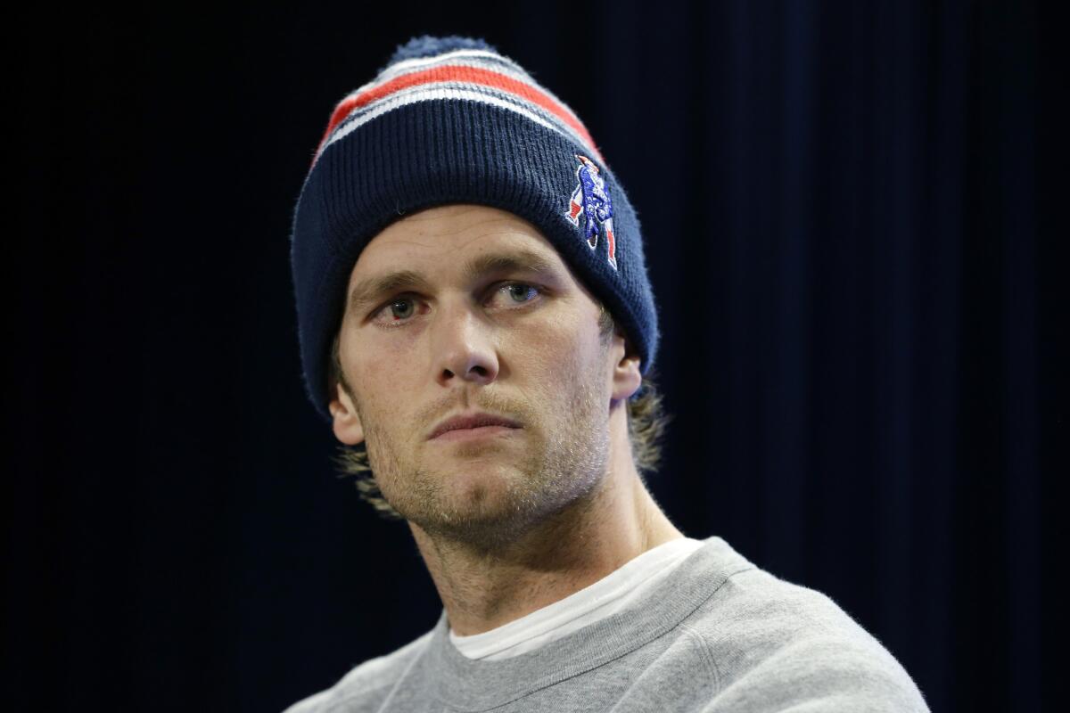 Patriots quarterback Tom Brady answers questions about the NFL investigation of deflated footballs last week. Brady isn't the first quarterback to have to address a scandal leading up to the Super Bowl