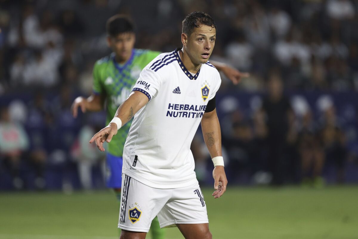 LA Galaxy forward Javier Hernández signals to a teammate during the first half of an MLS soccer match.