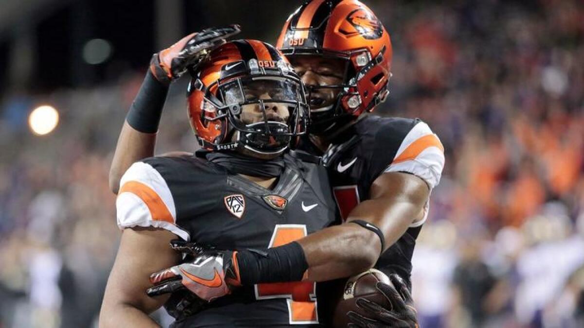 Oregon State running back Thomas Tyner (4) celebrates with a teammate after making a play against Washington on Sept. 30.
