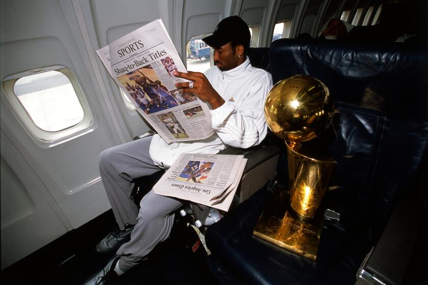  Kobe Bryant of the NBA Champion Los Angeles Lakers relaxes on board the Lakers' team flight back to Los Angeles.