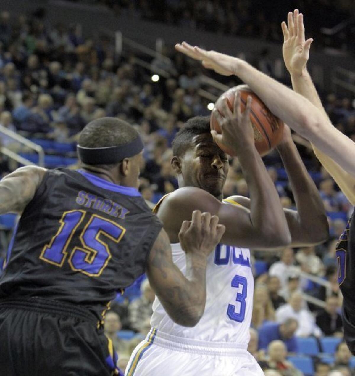 UCLA's Jordan Adams is smothered by Morehead State's defense during the first half on Nov. 22 at Pauley Pavilion.