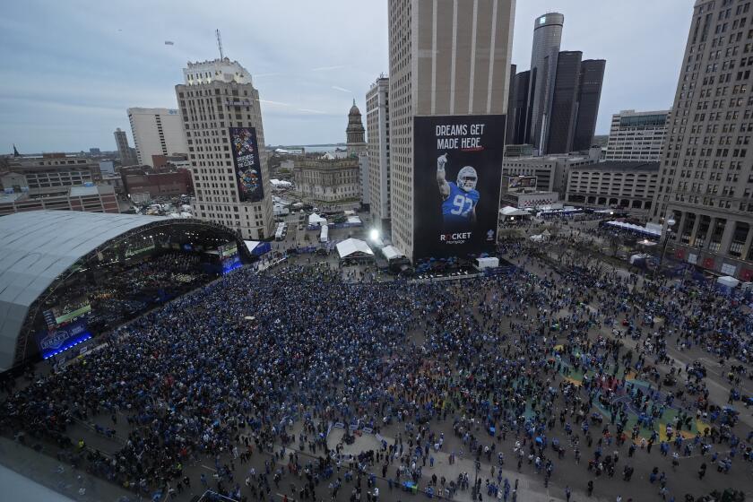 Crowds watch during the second round of the NFL football draft, Friday, April 26, 2024, in Detroit. (AP Photo/Paul Sancya)
