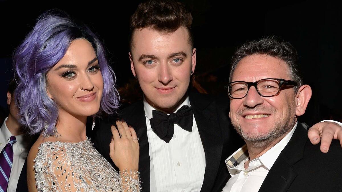 Katy Perry, left, Sam Smith and Universal Music Group's Chief Executive Lucian Grainge at a 2015 Grammys after-party.