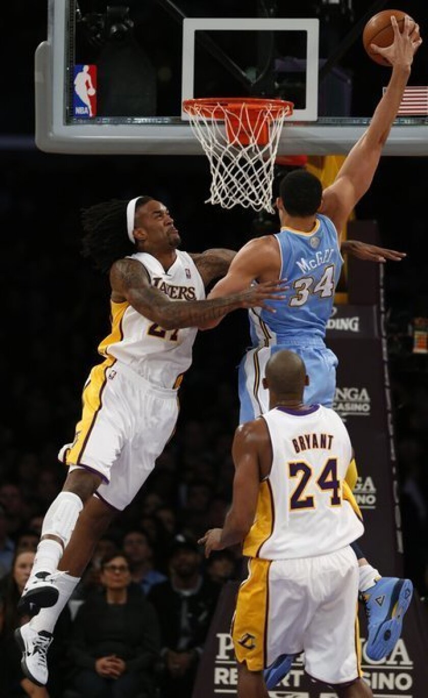 Nuggets center JaVale McGee tries to dunk over Jordan Hill during the game in which Hill was injured.