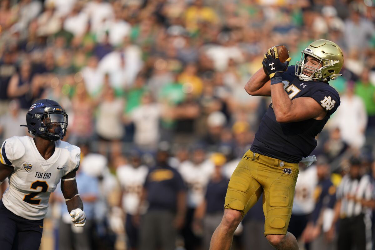 Notre Dame tight end Michael Mayer makes a TD catch in front of Toledo linebacker Dyontae Johnson on Sept. 11, 2021. 