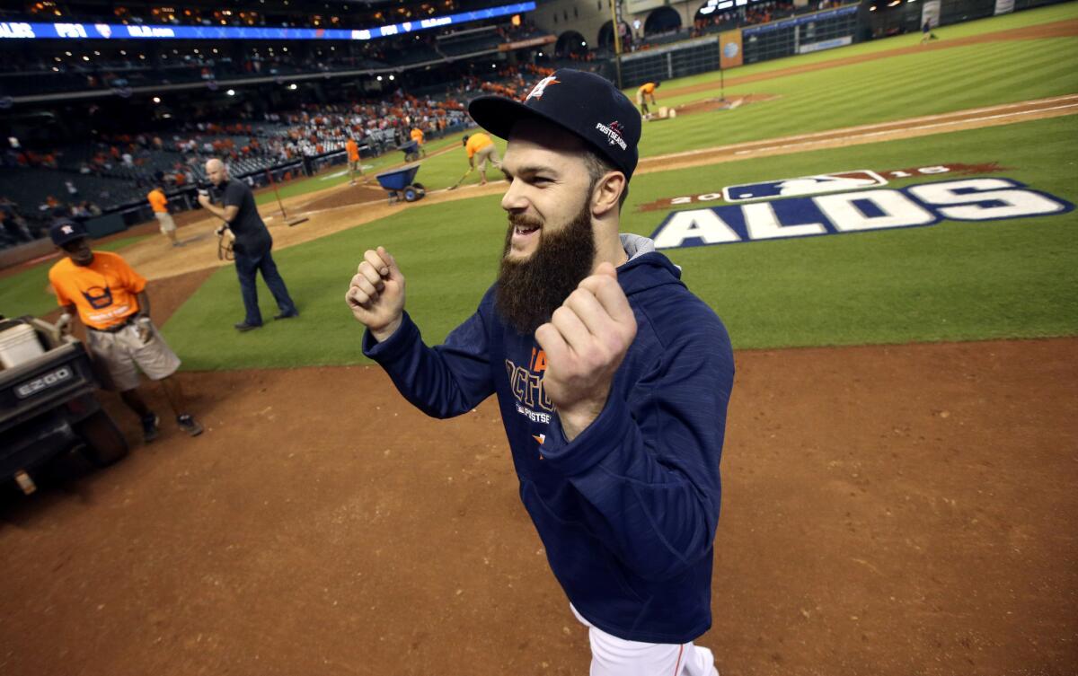 Astros starting pitcher Dallas Keuchel smiles as he gestures to the stands after winning Game 3 of the ALDS against the Royals.